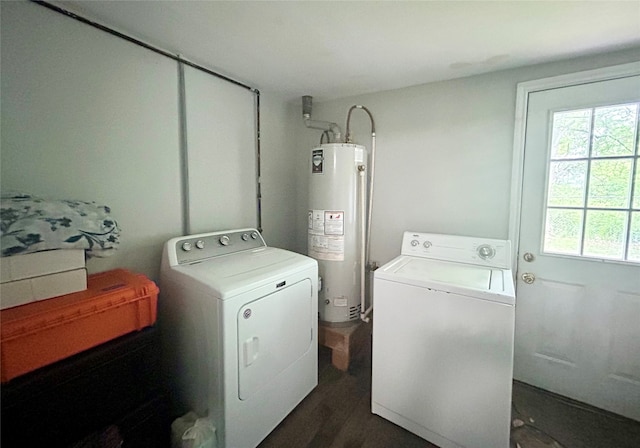 laundry room featuring washer and clothes dryer, gas water heater, and dark hardwood / wood-style floors