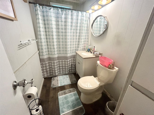 bathroom featuring wood-type flooring, toilet, vanity, and a shower with shower curtain