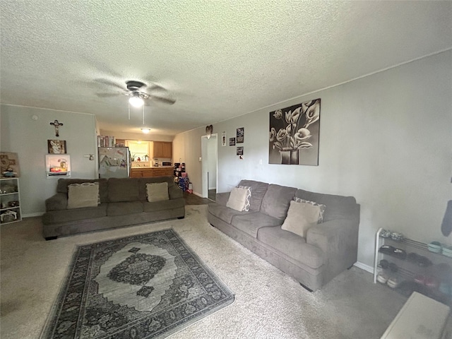 living room with a textured ceiling, carpet flooring, and ceiling fan