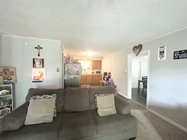 carpeted living room featuring a textured ceiling