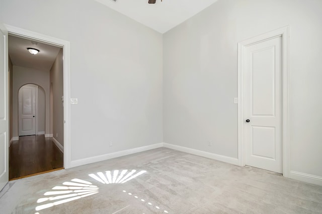 carpeted spare room with ceiling fan