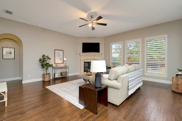 living room with dark hardwood / wood-style flooring and ceiling fan