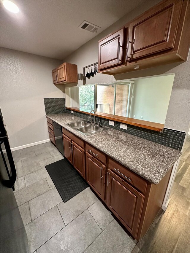 kitchen featuring black dishwasher and sink