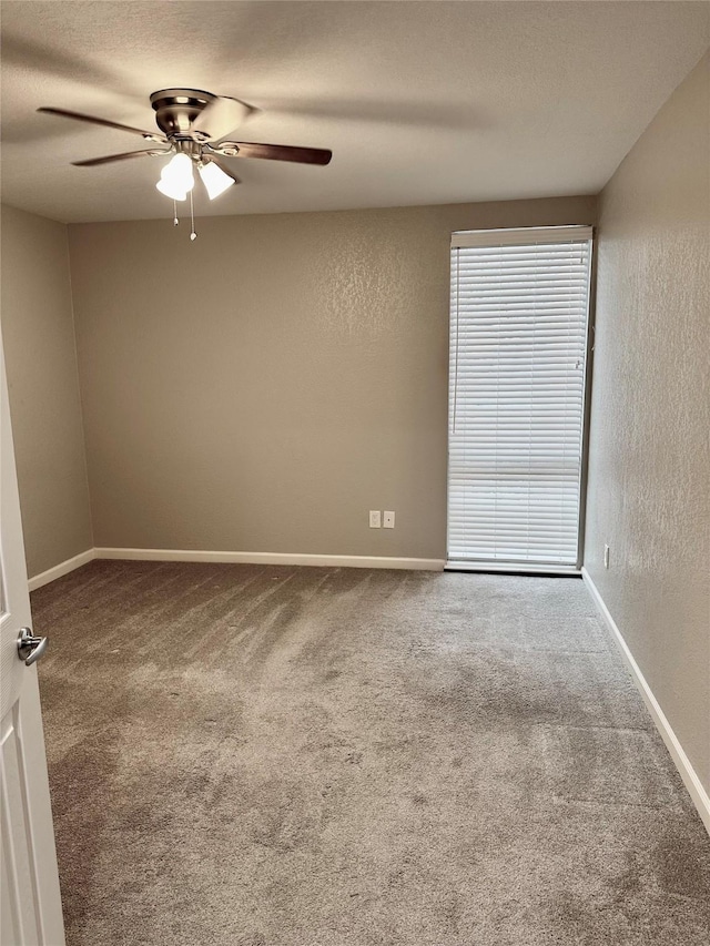 unfurnished room with ceiling fan, carpet floors, and a textured ceiling