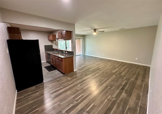 kitchen with hardwood / wood-style floors, ceiling fan, black appliances, and sink