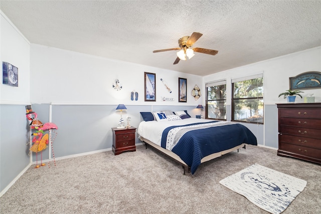 carpeted bedroom featuring ceiling fan and a textured ceiling