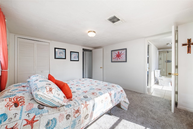 carpeted bedroom featuring connected bathroom and a closet