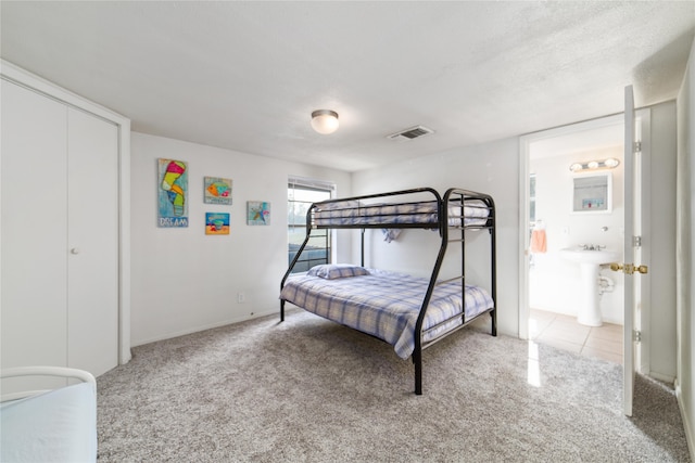 carpeted bedroom with ensuite bath