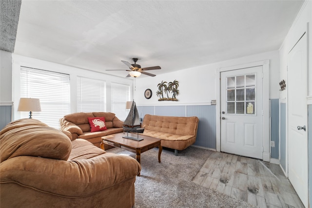 carpeted living room featuring ceiling fan and plenty of natural light