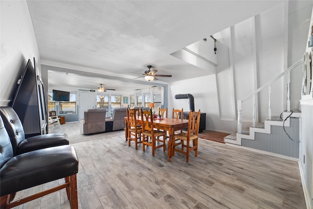 dining space featuring ceiling fan and light wood-type flooring