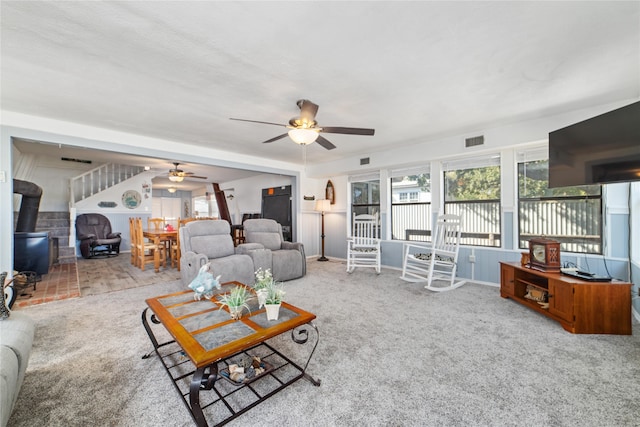 carpeted living room with ceiling fan