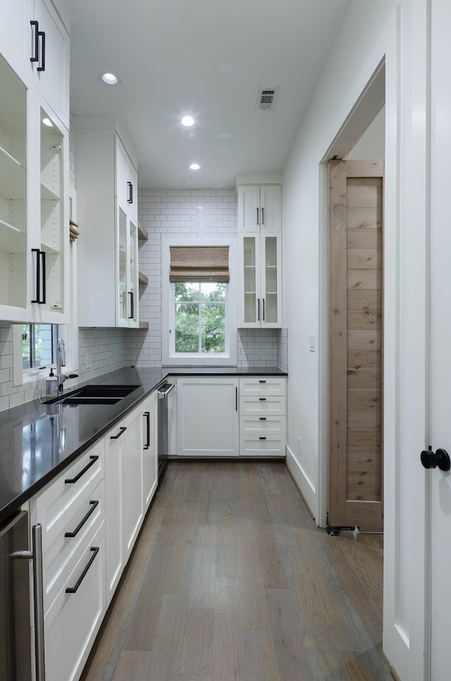 kitchen with white cabinets, a healthy amount of sunlight, sink, and dark hardwood / wood-style flooring