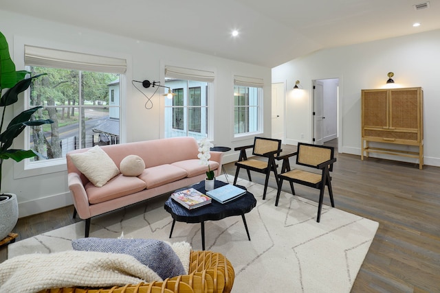 living room featuring dark hardwood / wood-style floors and vaulted ceiling