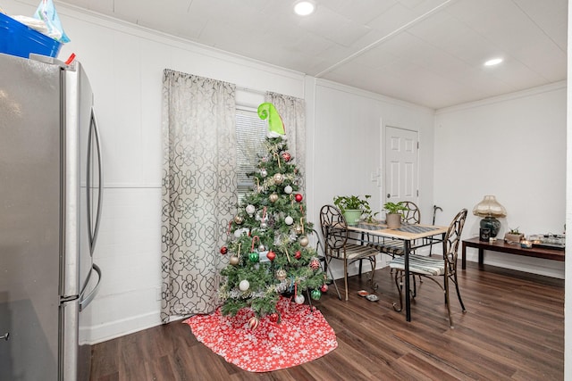 dining area featuring ornamental molding and dark hardwood / wood-style floors