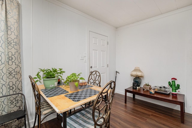 dining space featuring ornamental molding and dark hardwood / wood-style floors