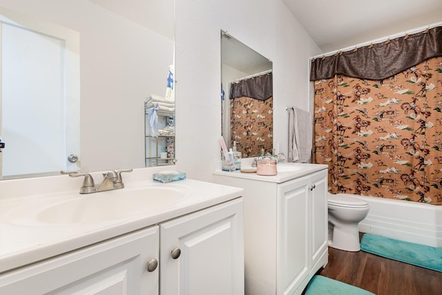 full bathroom with hardwood / wood-style flooring, vanity, shower / bathtub combination with curtain, and toilet