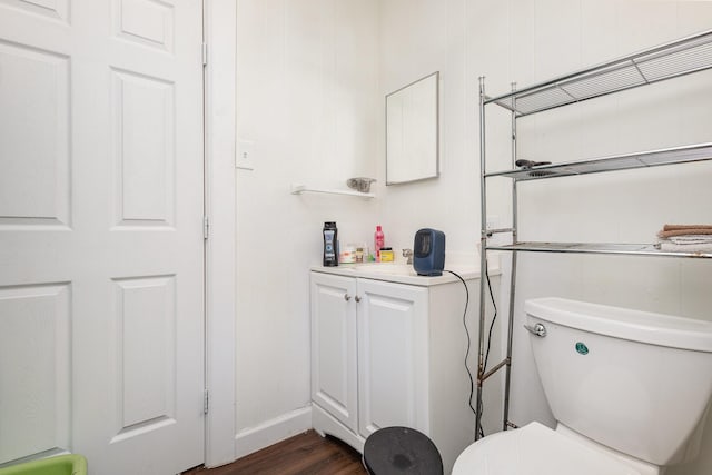 bathroom with hardwood / wood-style flooring, vanity, and toilet