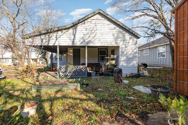 rear view of house with covered porch