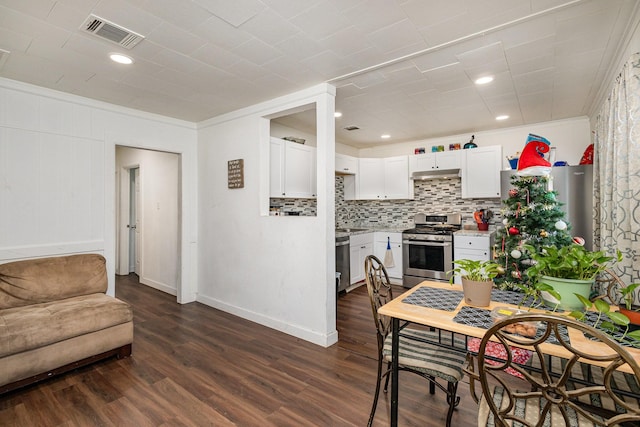 dining space featuring dark hardwood / wood-style flooring and ornamental molding