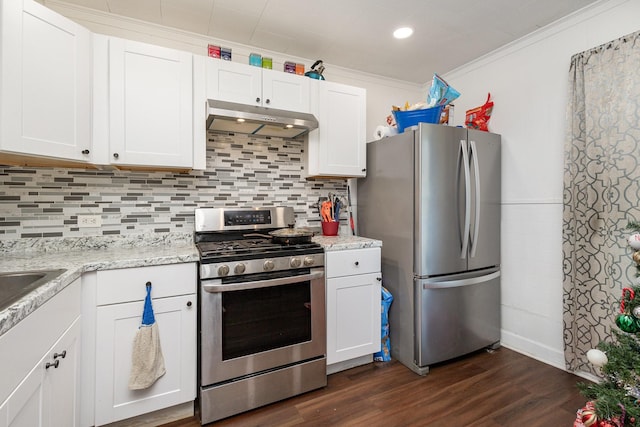 kitchen featuring crown molding, stainless steel appliances, dark hardwood / wood-style floors, tasteful backsplash, and white cabinets