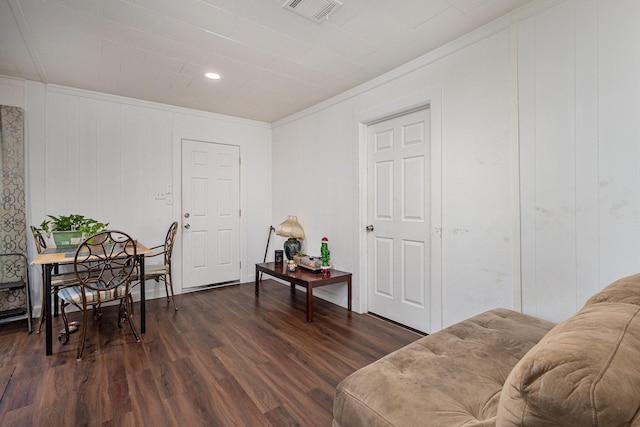 sitting room featuring crown molding and dark wood-type flooring