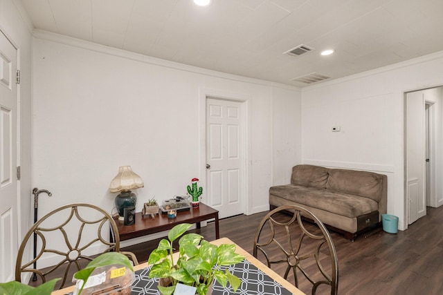 sitting room featuring crown molding and dark hardwood / wood-style floors