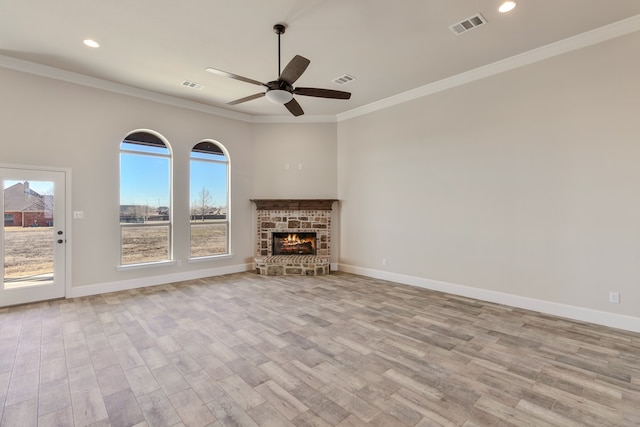 unfurnished living room featuring light hardwood / wood-style floors, a healthy amount of sunlight, and crown molding