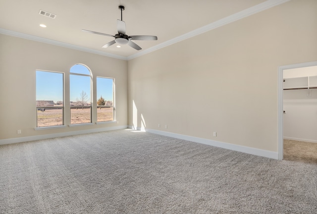 carpeted empty room featuring ornamental molding and ceiling fan