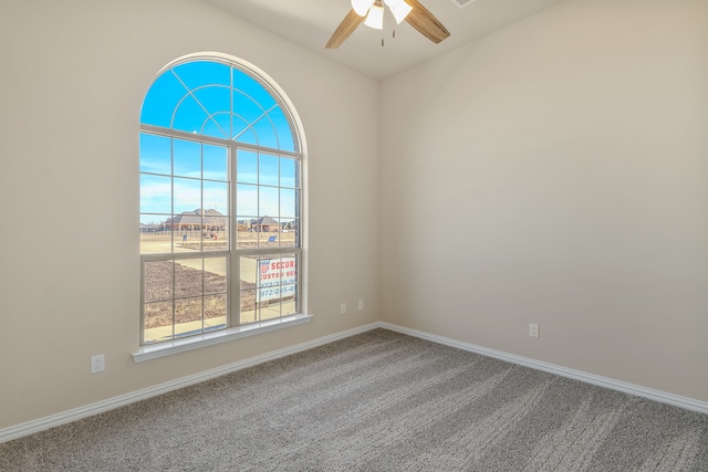 carpeted spare room with ceiling fan