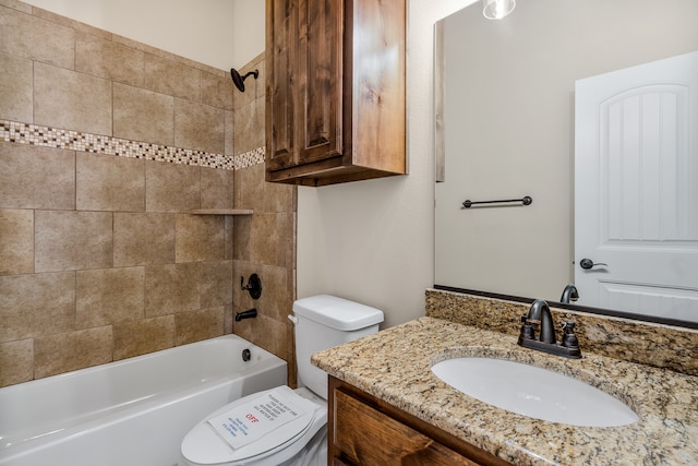 full bathroom featuring toilet, vanity, and tiled shower / bath