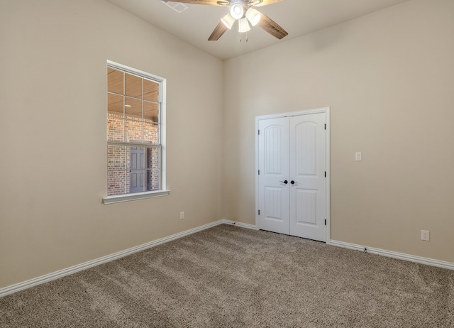 carpeted empty room with ceiling fan