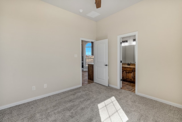 unfurnished bedroom featuring light carpet, ceiling fan, and ensuite bathroom