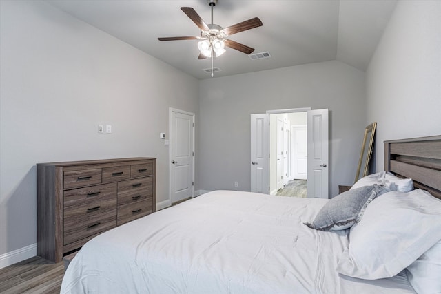 bedroom with light wood-type flooring, lofted ceiling, and ceiling fan