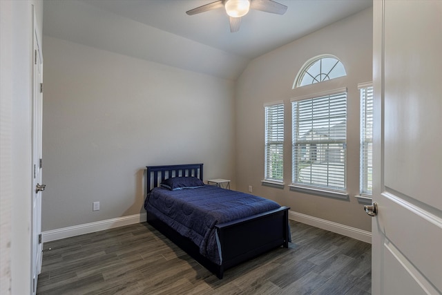 bedroom with dark wood-type flooring, ceiling fan, and vaulted ceiling