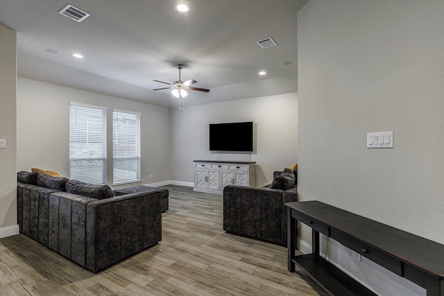 living room featuring ceiling fan and light hardwood / wood-style flooring