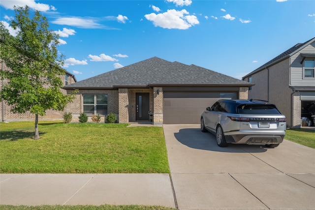 view of front of home with a garage and a front yard