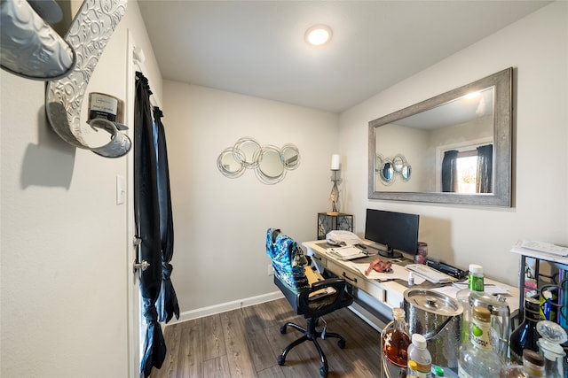 home office with dark hardwood / wood-style floors