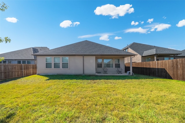 back of property featuring a patio and a yard