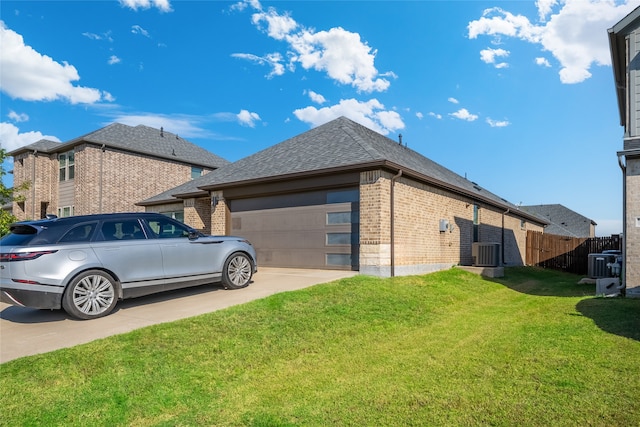 view of side of home with central air condition unit, a garage, and a lawn