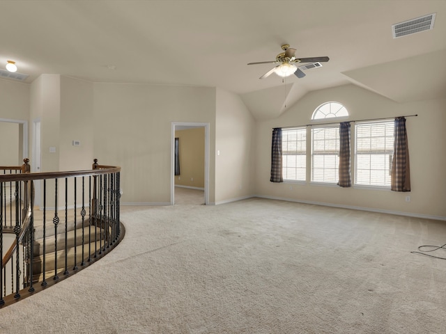 empty room featuring ceiling fan, carpet flooring, and vaulted ceiling