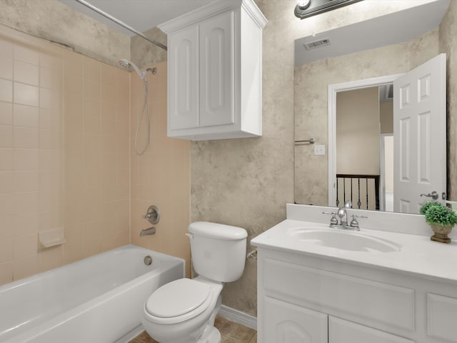 full bathroom featuring tile patterned flooring, vanity, toilet, and tiled shower / bath combo