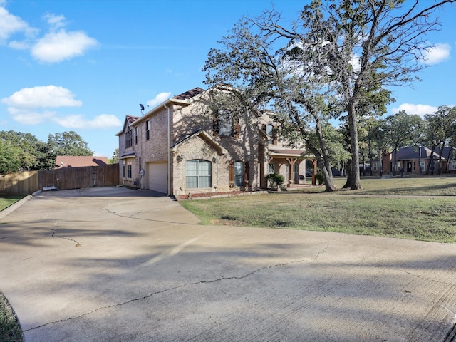 view of front of home with a garage and a front lawn