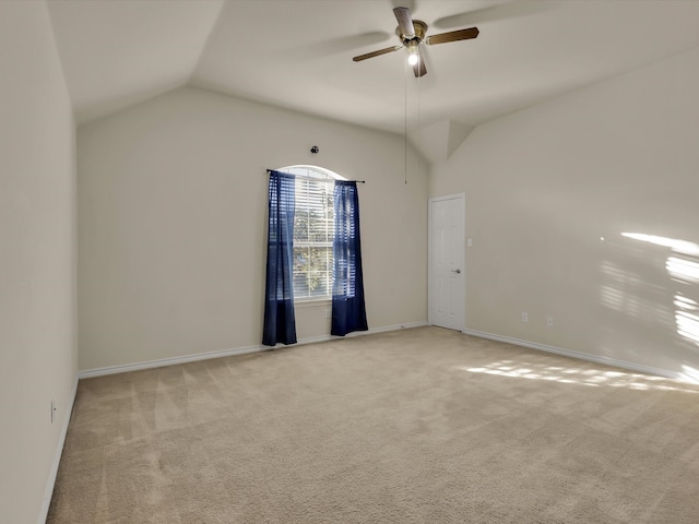 carpeted empty room with ceiling fan and vaulted ceiling