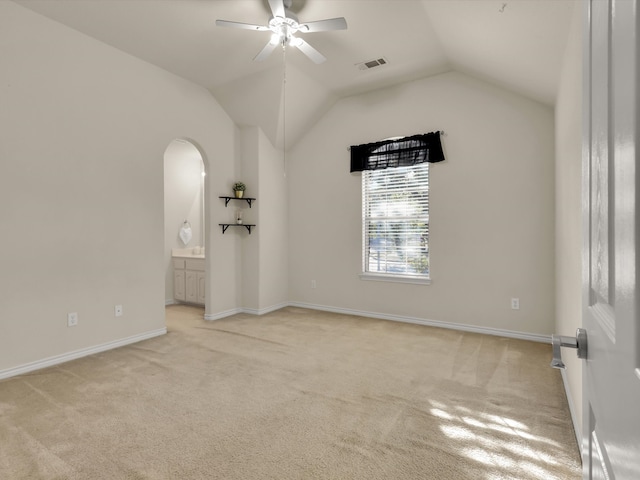 unfurnished room featuring light carpet, ceiling fan, and vaulted ceiling