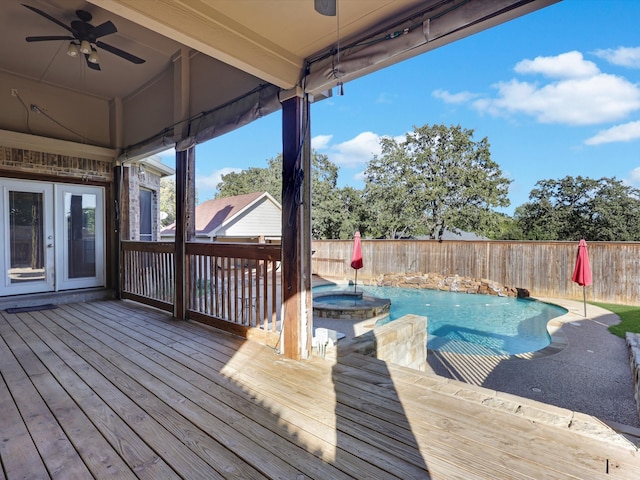 wooden deck with ceiling fan and a swimming pool with hot tub