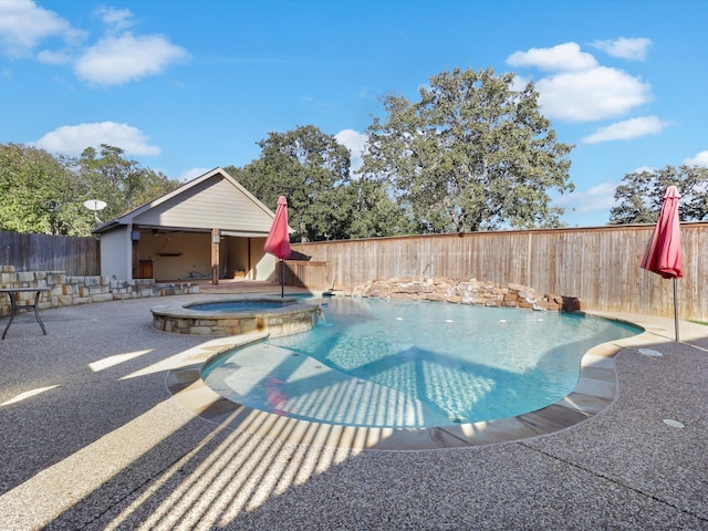 view of swimming pool featuring an in ground hot tub and a patio area