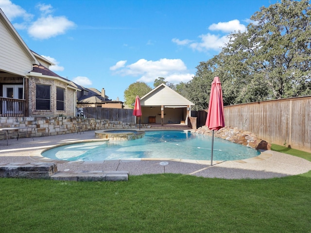 view of swimming pool featuring a patio, a yard, and an in ground hot tub