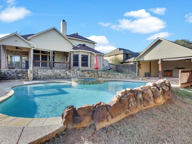 view of pool with a patio, ceiling fan, and an in ground hot tub