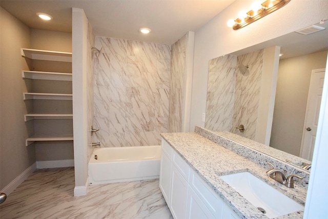 bathroom with vanity and tiled shower / bath combo