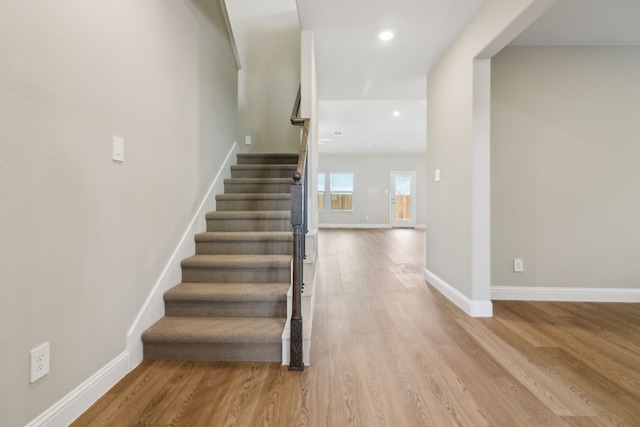 stairway featuring wood-type flooring